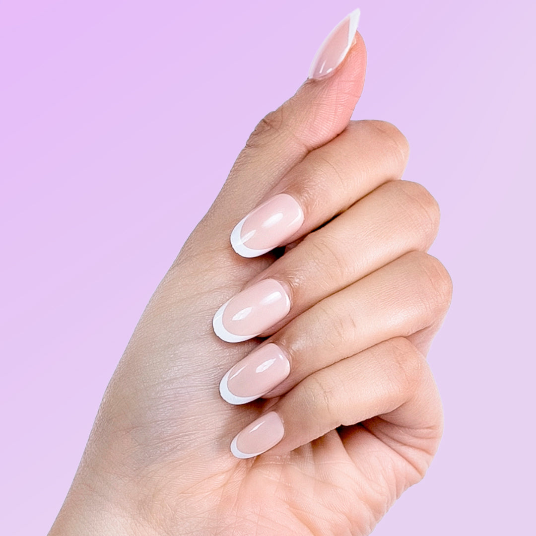 Model wearing Freshly Baked nude press on nails with classic French tip manicure.